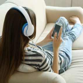 a young girl listeneing to the best audiobooks for kids in 2023