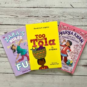 a selection of three books for 8 year olds on a white wood background