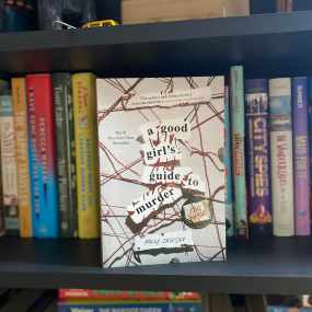 the book a good girls guide to murder sits face out on a shelf