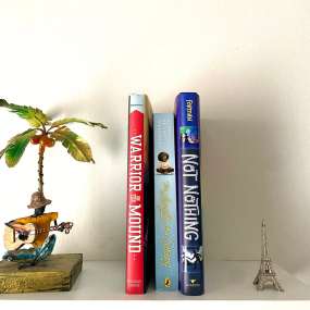 3 historical fiction books for 7th graders on a white floating shelf