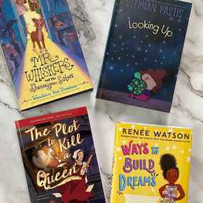 four october 2023 middle grade books splayed on a marble surface