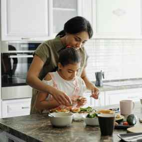 mother and daughter preparing avocado toast