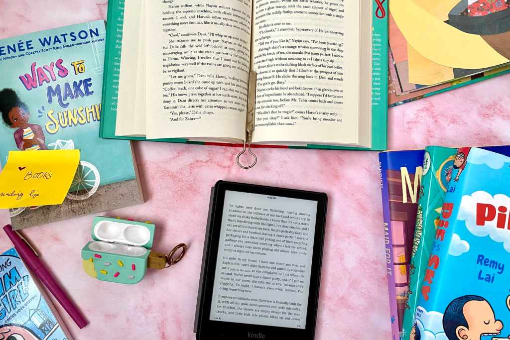a spread of items related to reading culture including a Kindle, books, bookmarks